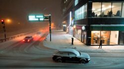 Heavy snow is set to begin tonight as authorities urge drivers to stay home, even while businesses push to operate as usual
